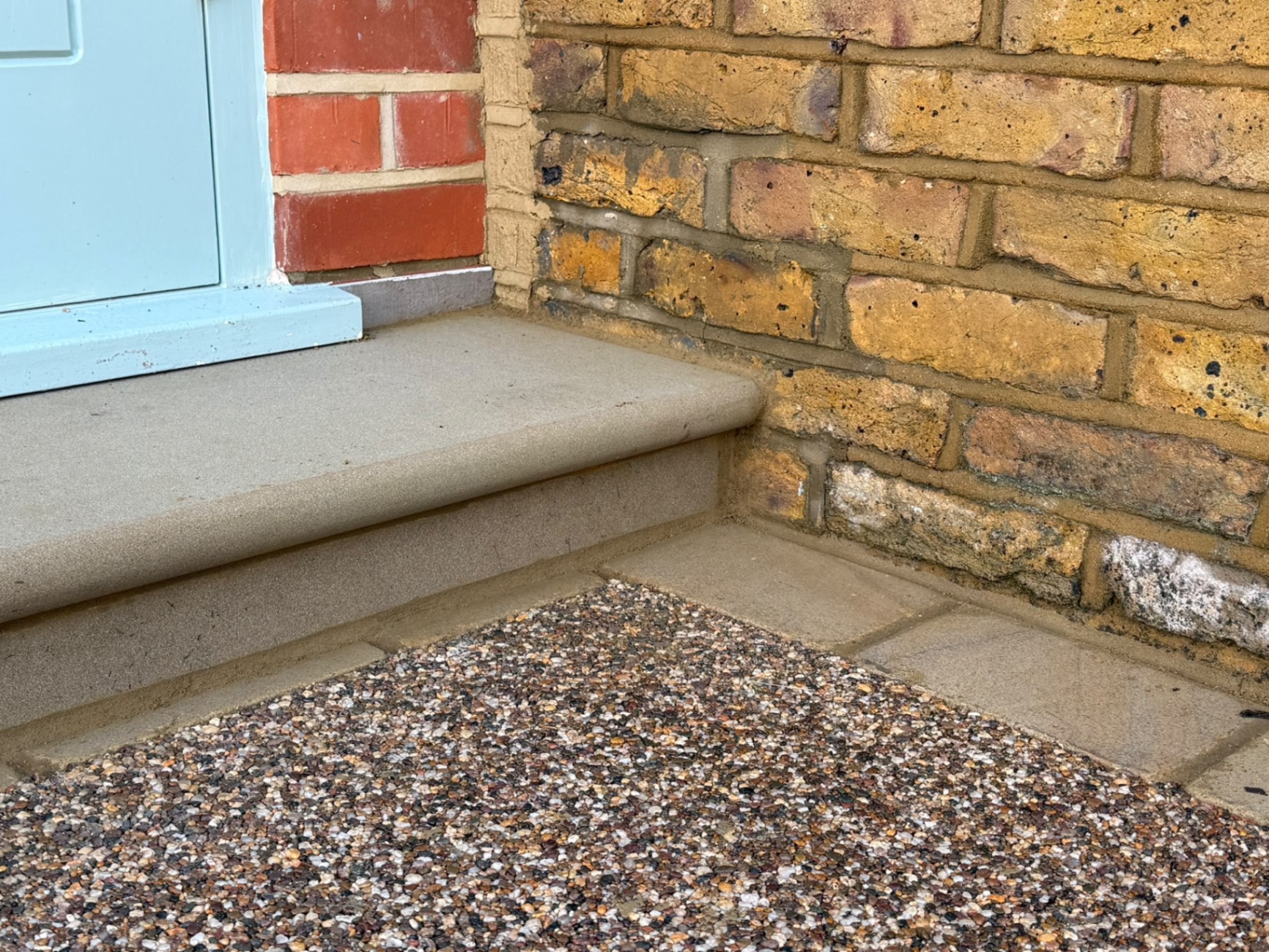 Detail of the sawn yorkstone step and edging meeting the resin-bound surface