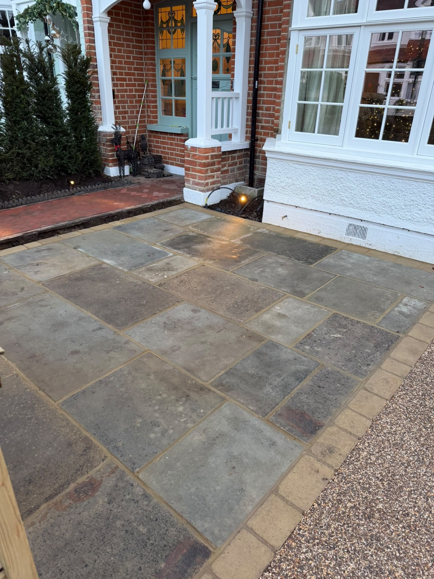 Close view of the reclaimed yorkstone paving and sawn edging beside the herringbone path