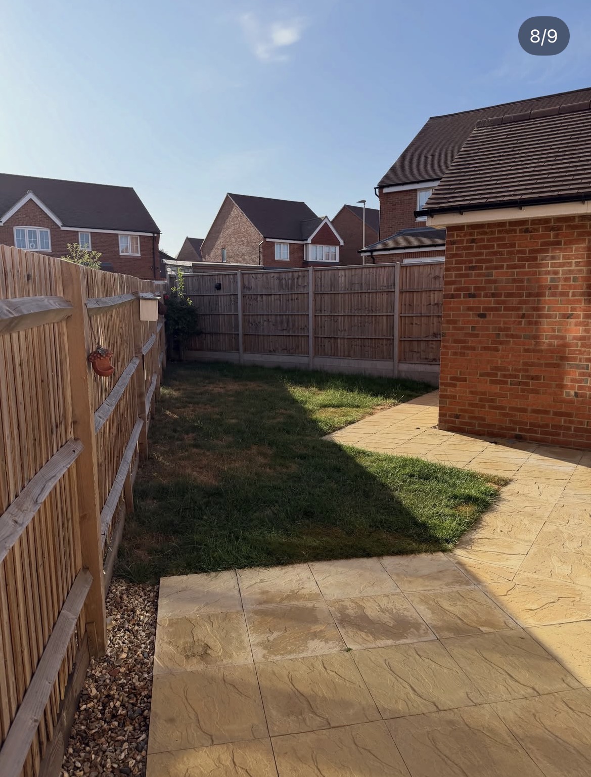 The garden before work began, with worn lawn and old paving