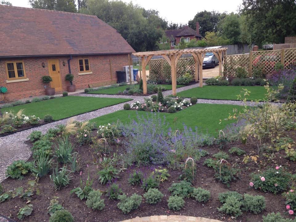 Wide view across the new lawns and flower beds towards the oak pergola