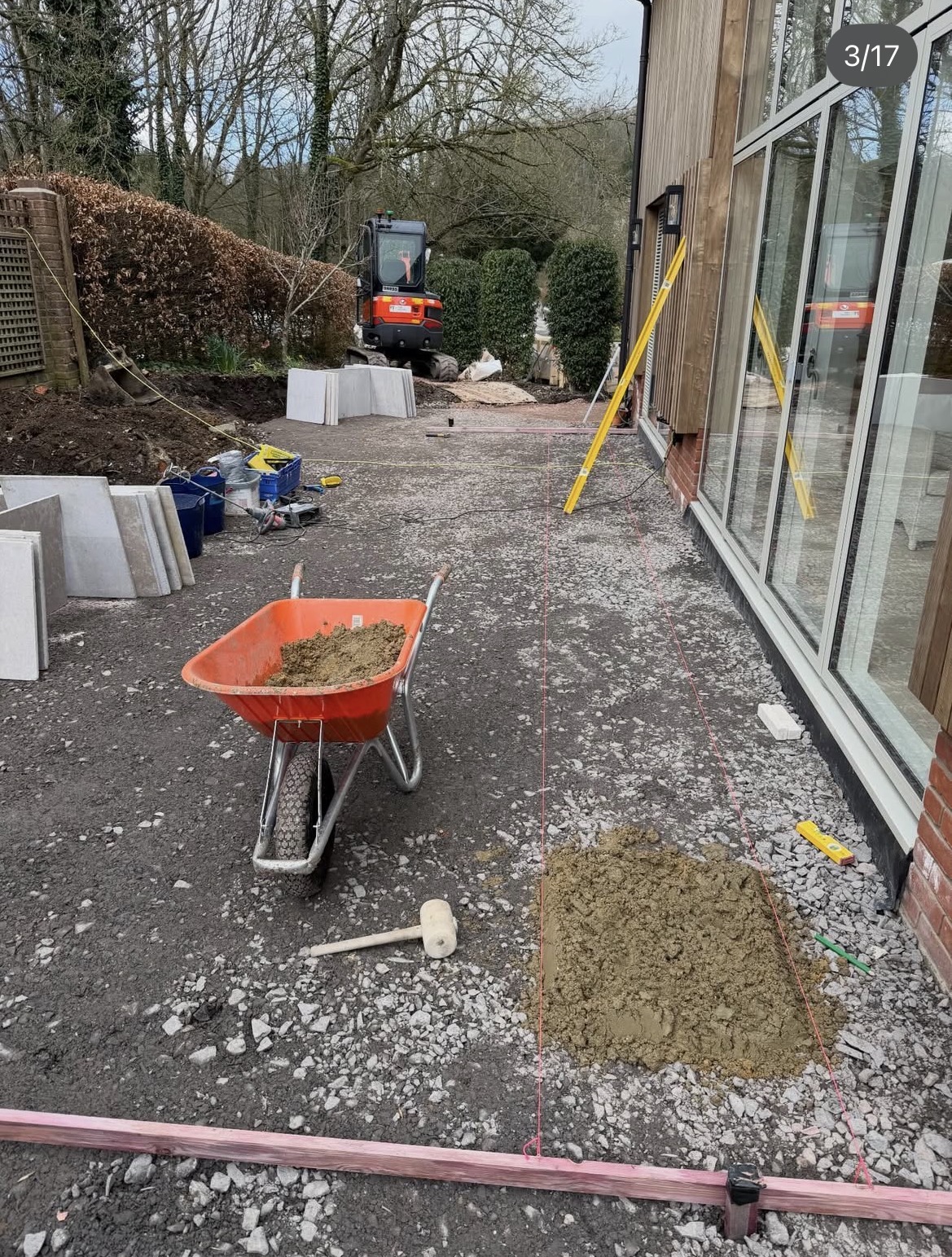 Early ground preparation beside the house before paving was installed
