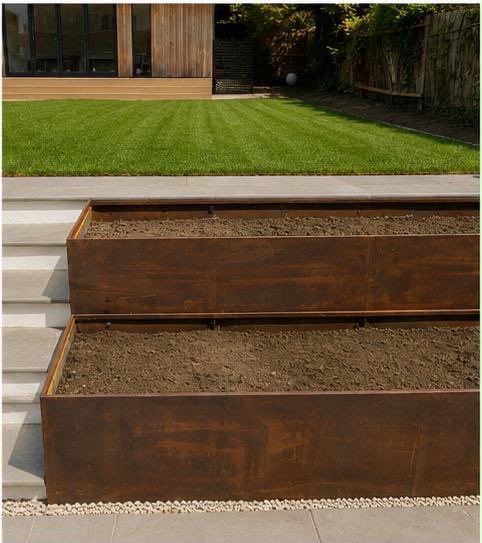 Tiered corten steel planters beside the finished limestone steps and white risers